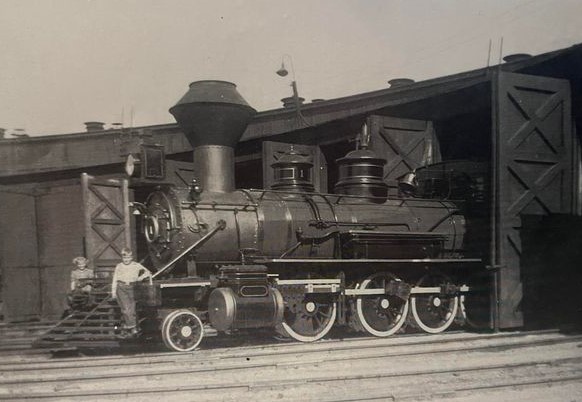 1950's - Santa Fe’s first engine, the Cyrus K. Holliday. Checking out locomotive Number One are children of a railroader boilermaker. The engine was put into service for the Santa Fe Railroad in Topeka, KS in 1869.